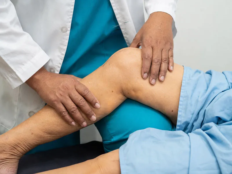 Doctor examining a patient's knee